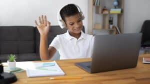 boy listening to his teacher during the online learning