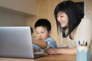 Mother with her kid taking online tuition class